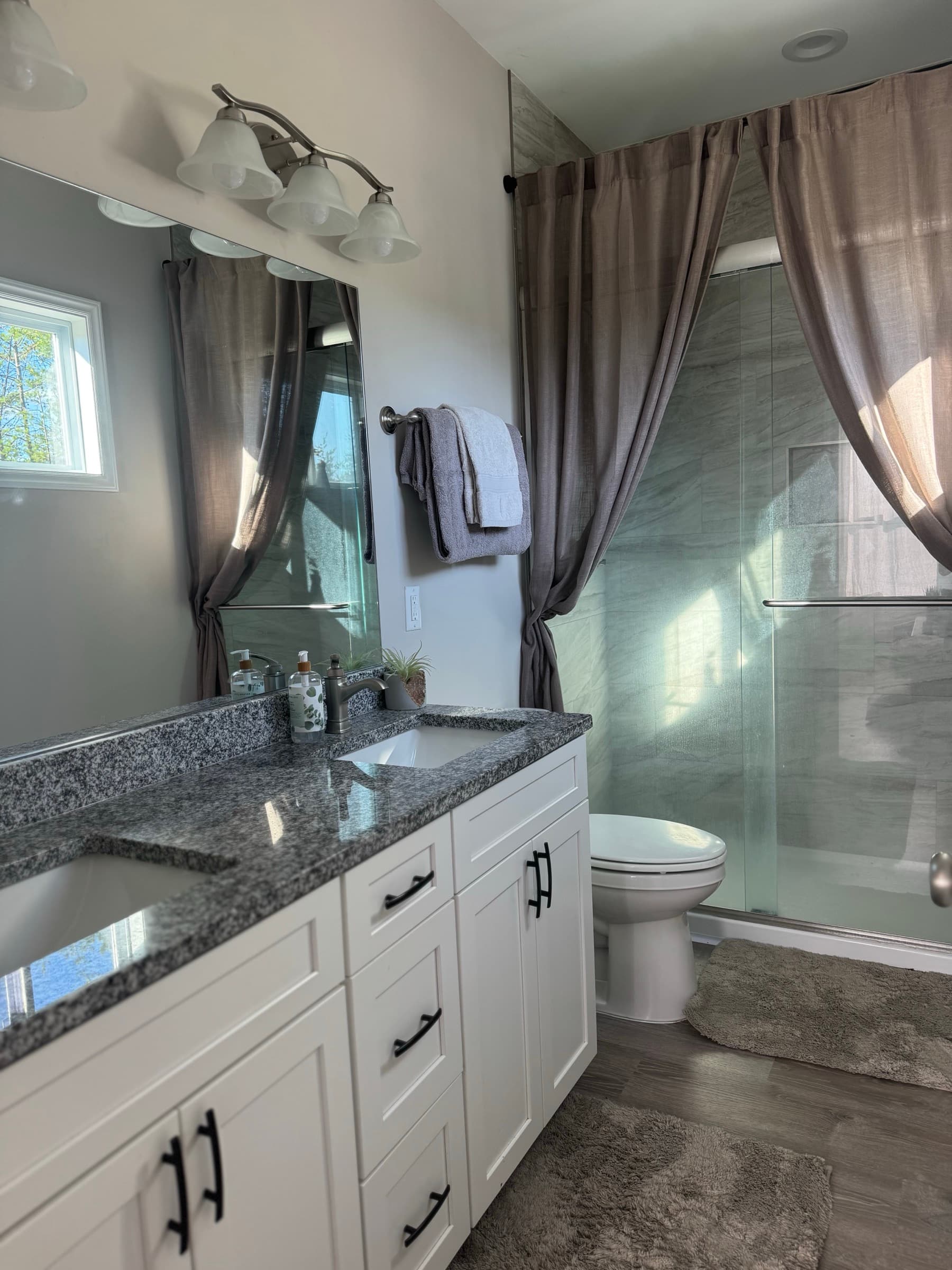 Clean double-vanity bathroom with walk-in shower